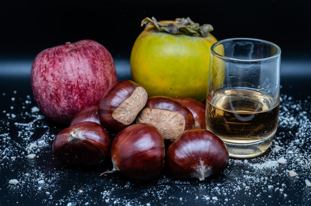 A composition of typically autumnal fruits such as chestnuts, persimmons or the apple, enhancing their beauty and detail.の写真素材