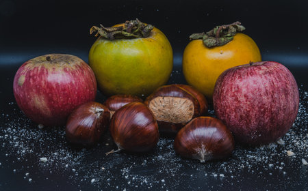 A composition of typically autumnal fruits such as chestnuts, persimmons or the Campanian Annurca apple, enhancing their beauty and detail.の写真素材
