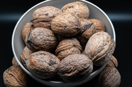 A composition of typically autumnal fruits such as walnuts, enhancing their beauty and detail.の写真素材