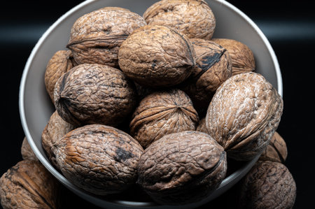 A composition of typically autumnal fruits such as walnuts, enhancing their beauty and detail.の写真素材