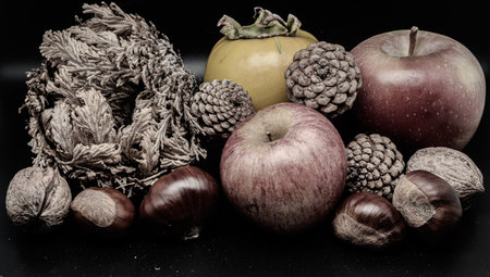 A composition of typically autumnal fruits such as walnuts, enhancing their beauty and detail.の写真素材
