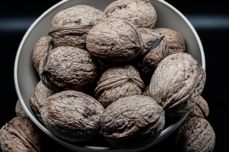 A composition of typically autumnal fruits such as walnuts, enhancing their beauty and detail.の写真素材