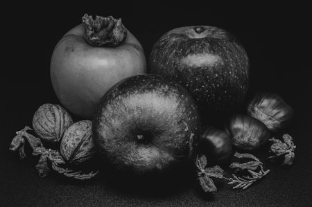 A composition of typically autumnal fruits such as chestnuts, walnuts, persimmons or the Campanian Annurca apple, enhancing their beauty and detail.の写真素材