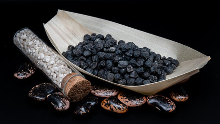 A composition of black beans, black chickpeas and rice, which enhances their beauty and detailsの写真素材