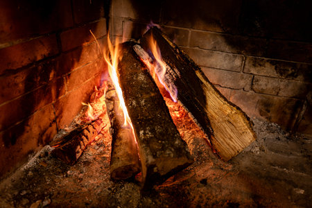 In winter, while it snows outside and the polar cold rages, the wood-burning fireplace with its magic and warmth, holds you in a warm and relaxing embrace.の写真素材