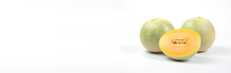 Fresh melon cut on a white background, macro. Studio shooting of a fruit useful in vitamins. AI generated. Header banner mockup with space.の素材