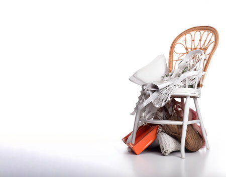 A bunch of things are lying on a chair, a mess. White background, isolate. Header banner mockup with copy space. AI generated.の素材