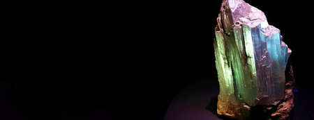 agrellite is a rare precious natural geological stone eremite on a black background in low key. Fashionable jewelry elegant decoration. AI generated. Header banner mockup with space.の素材