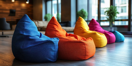 Multicolored bean bag chairs are neatly placed in a cozy contemporary environment with large windows allowing natural light. This setup invites relaxation and casual gatherings.の素材
