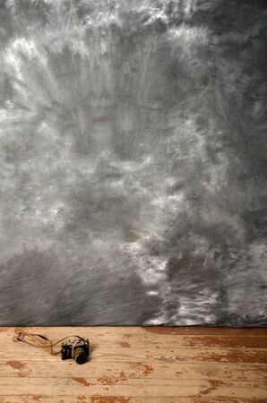 Studio background and ancient photo camera on the wooden floorの写真素材