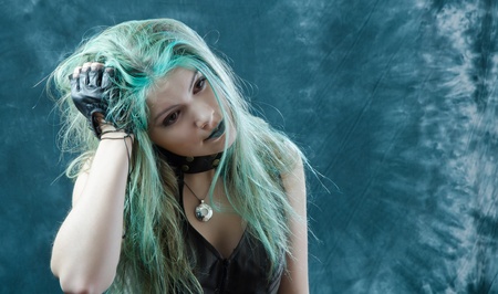 Photo session of the pretty young blonde girl with green hair in the steampunk styleの写真素材