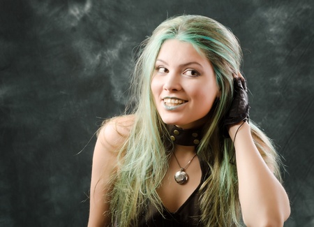 Photo session of the pretty young blonde girl with green hair in the steampunk styleの写真素材