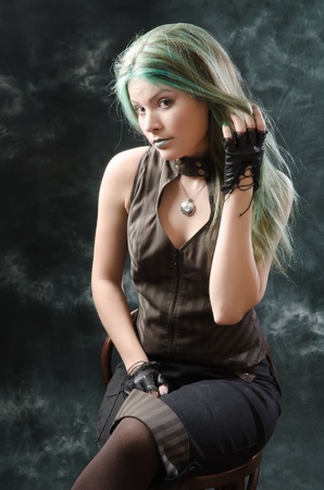 Photo session of the pretty young blonde girl with green hair in the steampunk styleの写真素材