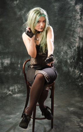 Photo session of the pretty young blonde girl with green hair in the steampunk styleの写真素材