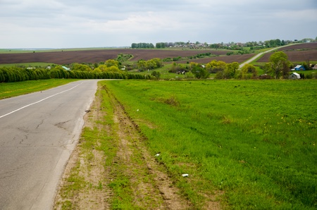 Two-line road bends through the spring countrysideの写真素材
