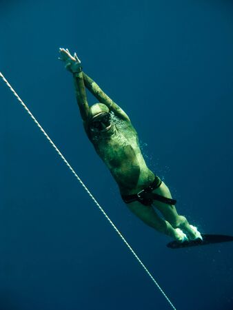 Freediver rises up near the safety rope in Blue Hole, Dahab, Egyptの写真素材