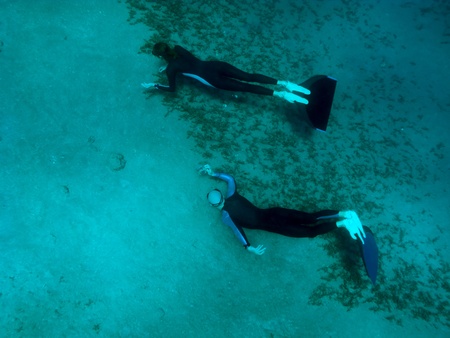 One freediver takes photo of another at the sand bottom of the Red Seaの写真素材