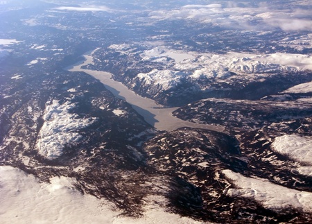 Aerial view of the distant scandinavian fiord, mountains and cloudsの写真素材