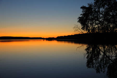 The final stage of a sunset above the huge lake in Karelia region. The picture is colorful and relaxing.の写真素材