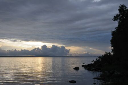 The picture shows rainstorm and thunderstorm clouds over lakeの写真素材