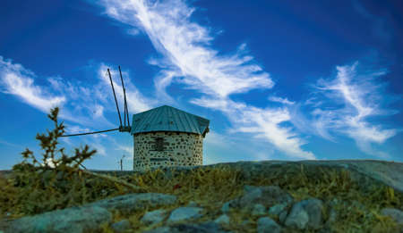 Symbol of the city of Bodrum (Turkey) ancient windmill on a hill. Blue sky with clouds.の写真素材