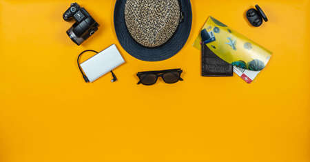 Travel accessories on intense yellow background in the center.の写真素材