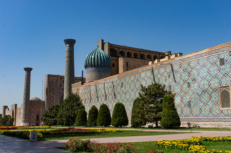 Side view of the Sherdor Madrasah on Registan Square in Samarkand, Uzbekistan. Flower beds.の写真素材