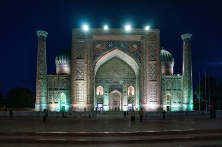 Sherdor Madrasah on Registan Square with festive evening color lighting in Samarkand, Uzbekistan.の写真素材