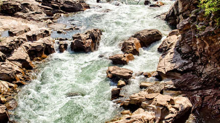The mountain river runs between the stones on summer day. Landscape. Russia. Adygea. Outdoors. Horizontal format. Without people color. Photo.の写真素材