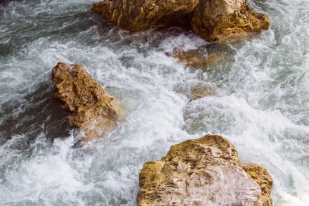 Stormy streams of the mountain river and stones in the summer. Landscape. Outdoors. Horizontal format. Color. Photo.の写真素材