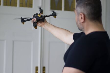 Man holds a drone in his handの写真素材