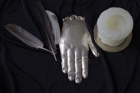 Occultism symbolic objects, human figures, bird feathers, candleの写真素材
