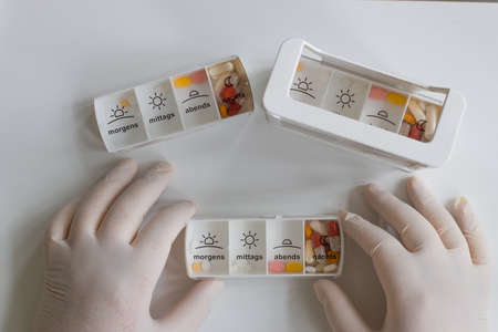 human hands sort tablets into boxesの写真素材