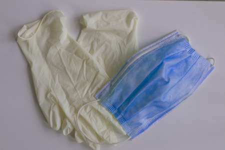 Medical mask and gloves lie on the tableの写真素材