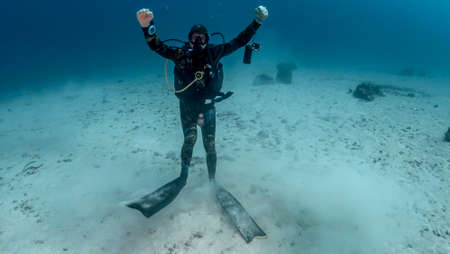 Diver captures underwater world on cameraの写真素材