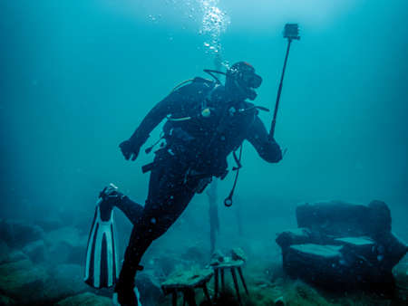 Diver captures underwater world on cameraの写真素材