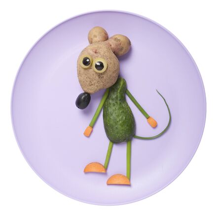 Mouse compiled from fresh vegetables on purple plateの写真素材