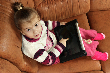 the little girl uses the tabletの写真素材