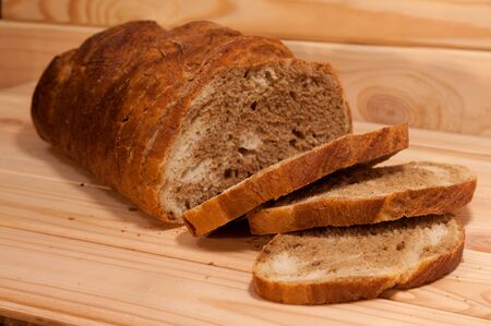 marble sliced ??wheat - rye bread on a wooden boardの写真素材