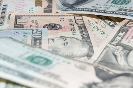 Background of scattered ten and twenty dollar bills close-upの写真素材
