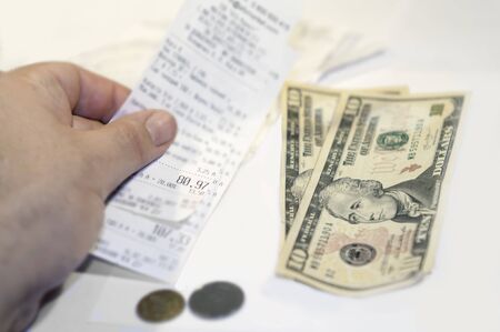 The lack of funds for paying bribes. Ten dollar denominations, small coins and receiptの写真素材