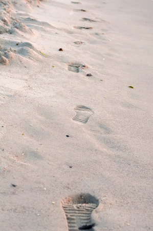 female footprints, on the sand seaの写真素材