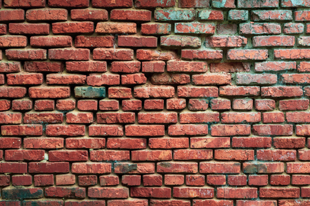Background from an old brick wall with red bricks with a shabby textureの写真素材