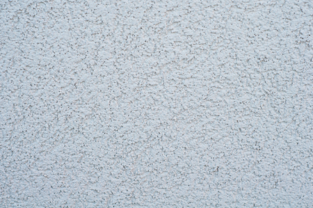 horizontal background of a wall with applied decorative gray uneven rough plasterの写真素材