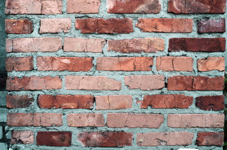 Background from old red brick with cracks close up