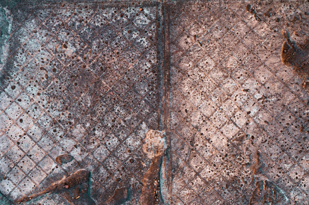 background of old darkened scuffed and scratched gray concrete floor with traces of floor tilesの写真素材