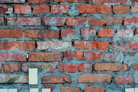 Background from old shabby bare bricks close upの写真素材