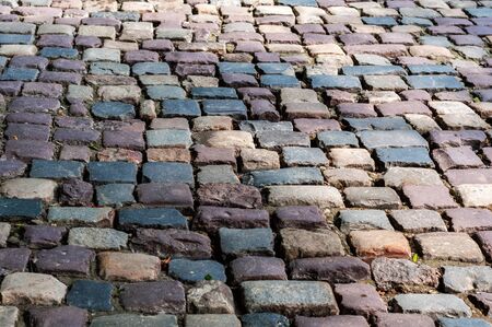 Pavement of smooth textured old natural stone of different shadesの写真素材