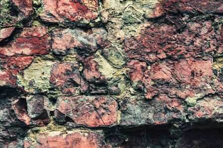 background of old rough concrete plaster and red brick brickworkの写真素材