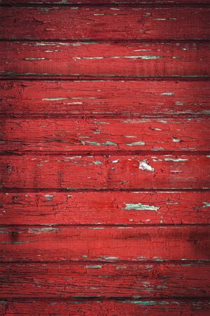 Background from horizontal old boards with red peeling paintの写真素材